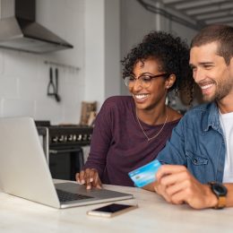 Happy multiethnic couple making online payment
