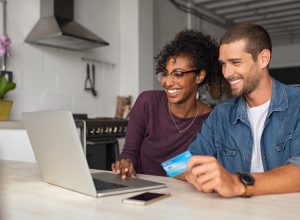 Happy multiethnic couple making online payment