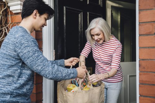 boy helping elderly women with groceries, ways to feel amazing
