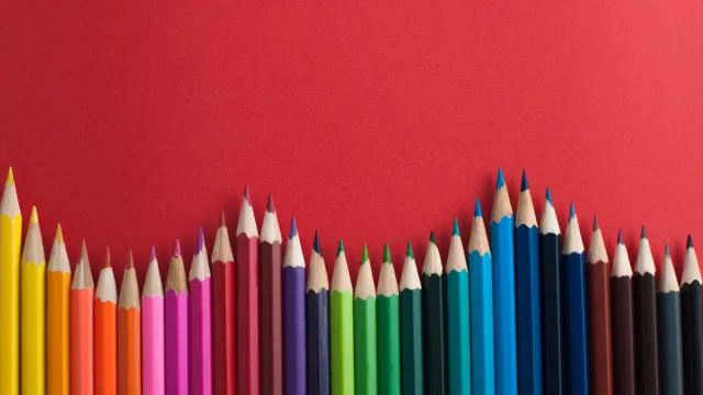 colored pencils against a red background - color facts