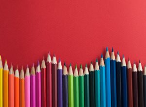 colored pencils against a red background - color facts