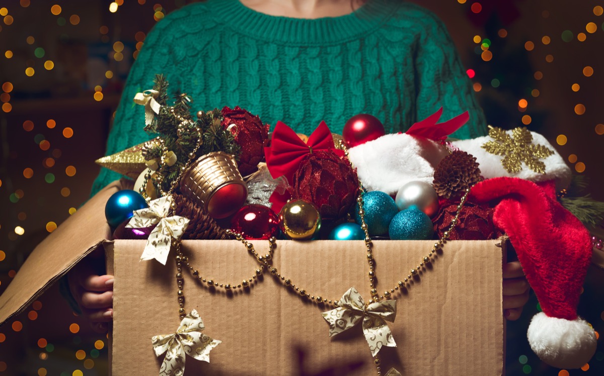 woman holding a box of christmas decorations