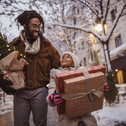 a young family preparing to give back this holiday season with presents in hand