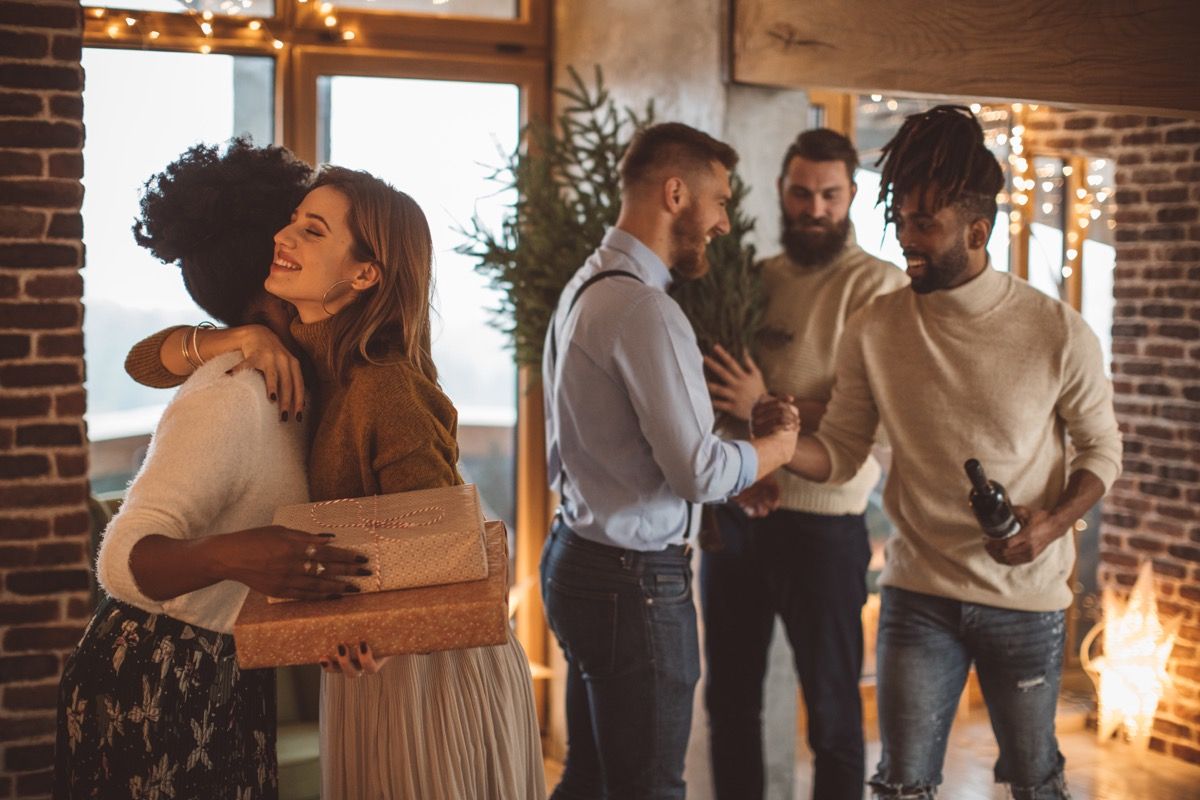 guests hugging hosts goodbye at a holiday party