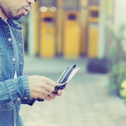 man with a beard pulling cash out of his wallet, worst things about the suburbs