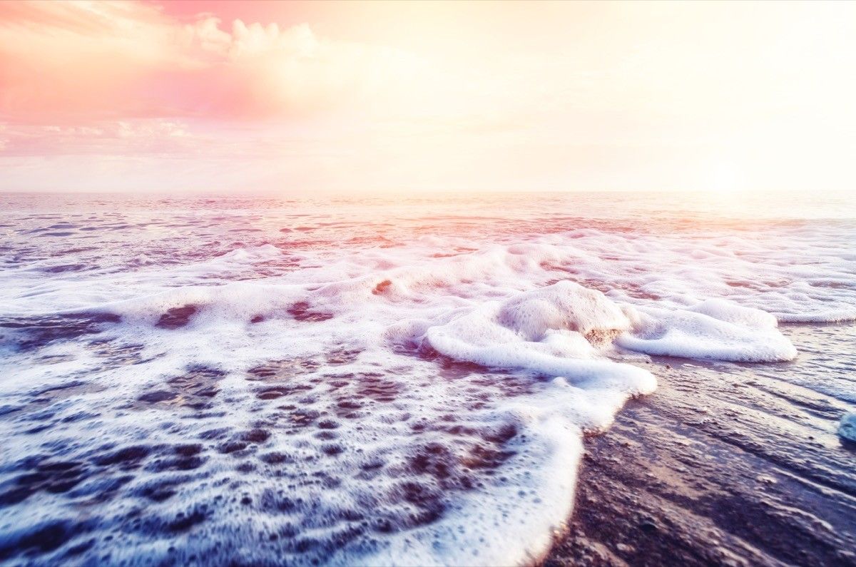 Foamy ocean waves on beach