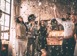 people celebrating all the good news in 2018 with a confetti party