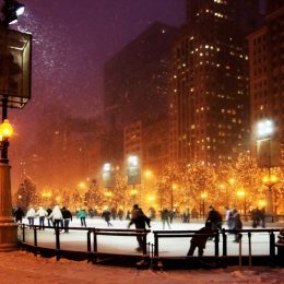 people ice skating in chicago during a snow storm at night