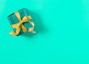 a perfectly wrapped present against a tiffany blue background