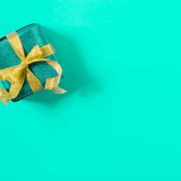 a perfectly wrapped present against a tiffany blue background