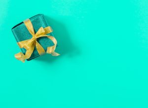 a perfectly wrapped present against a tiffany blue background