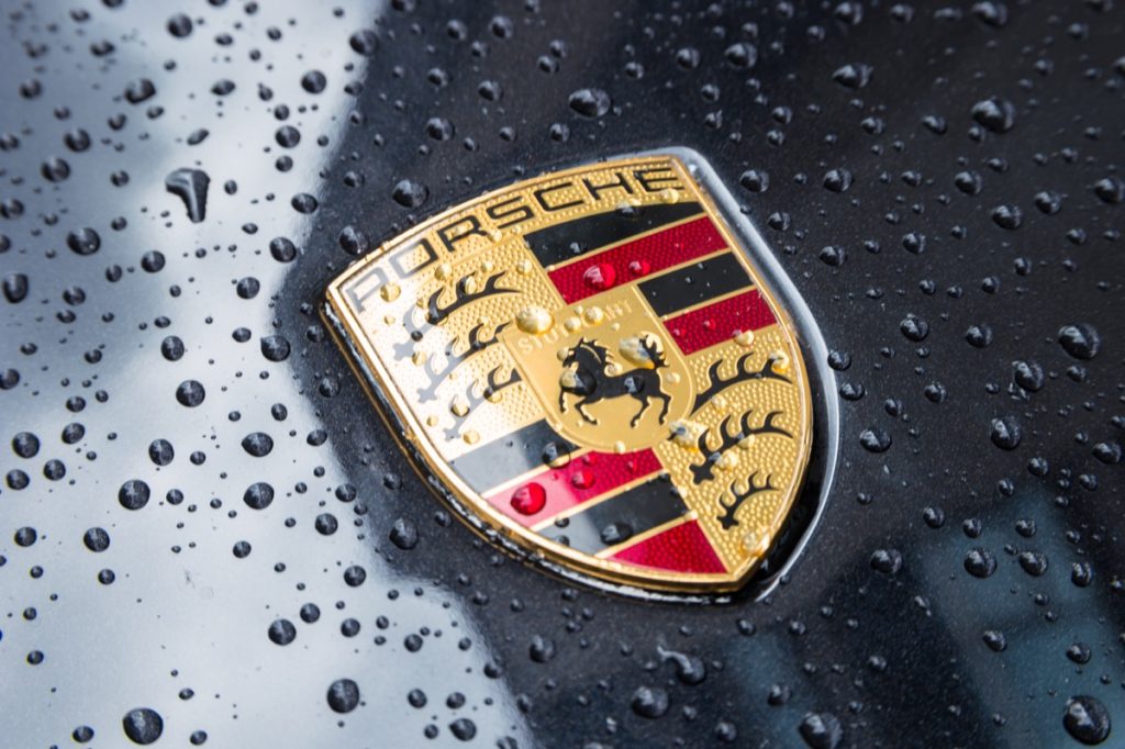 Close up on logo of porsche car in the rain
