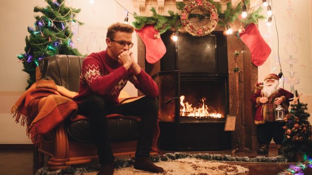 Sad Man Sitting By a Christmas Tree {How I Cope With Christmas Depression}