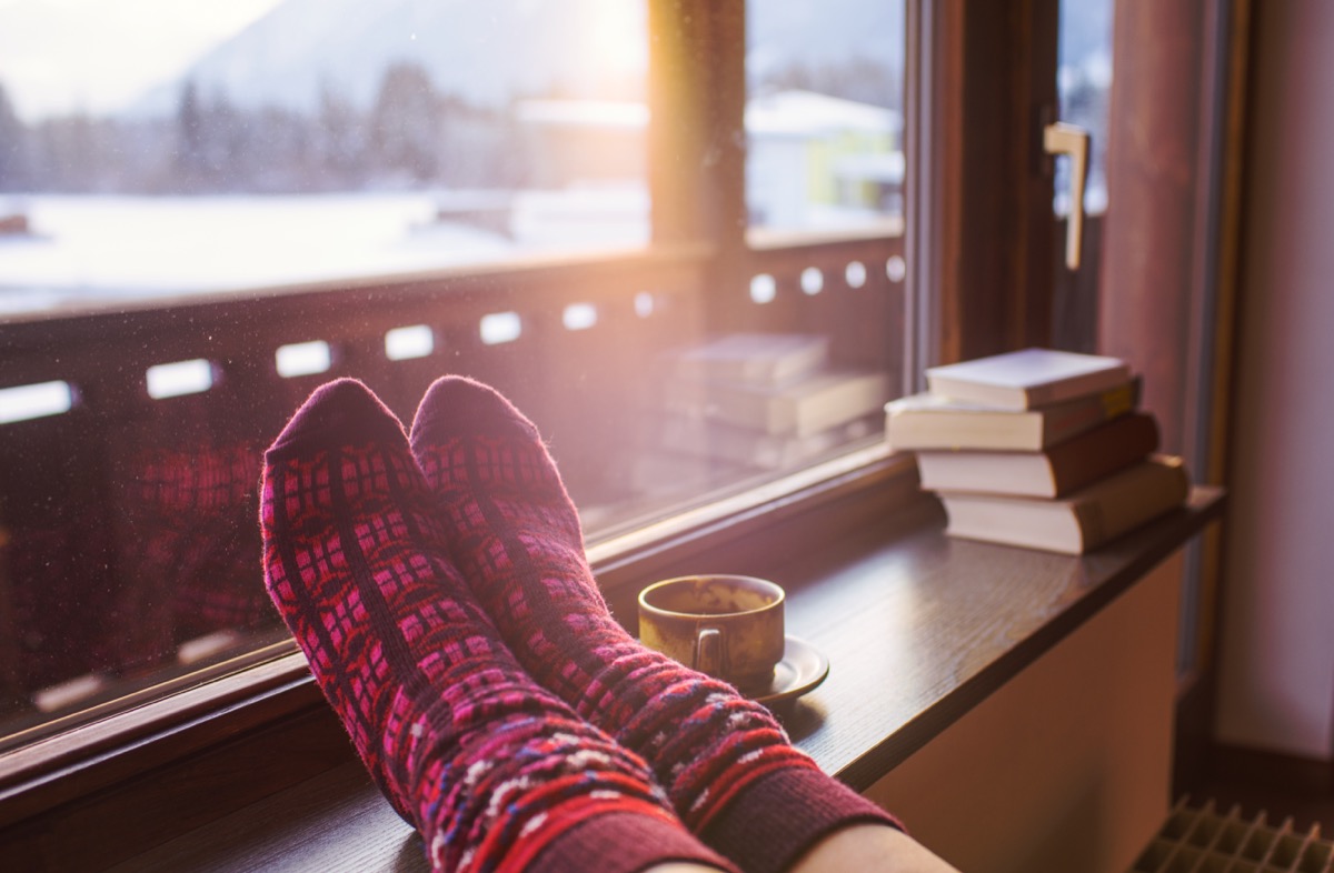 socks on a heater next to books and a cup of tea in a home in winter, math jokes