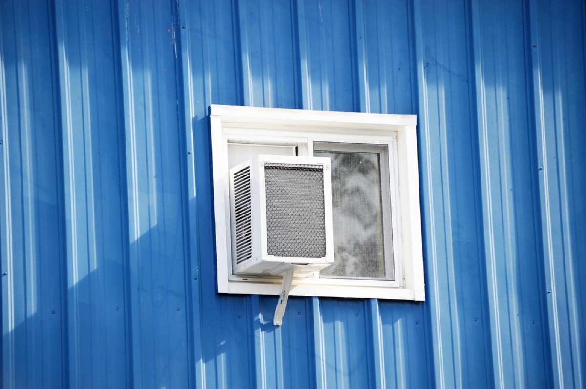window air conditioning unit on house with blue siding