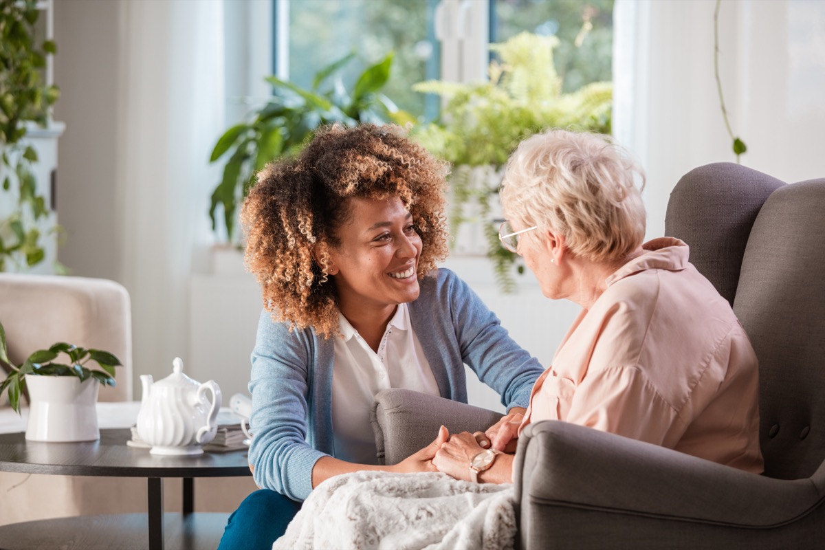 woman talking to elderly woman in a nursing home