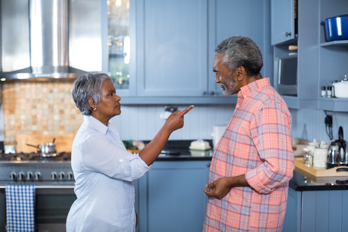 Unhappy senior black couple standing in kitchen while wife points finger