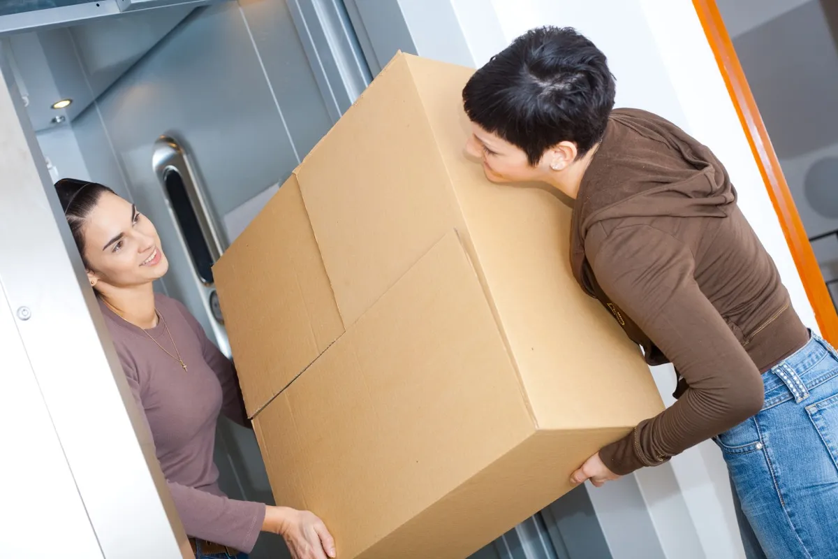 women moving heavy boxes {Ikea Shopping Secrets}