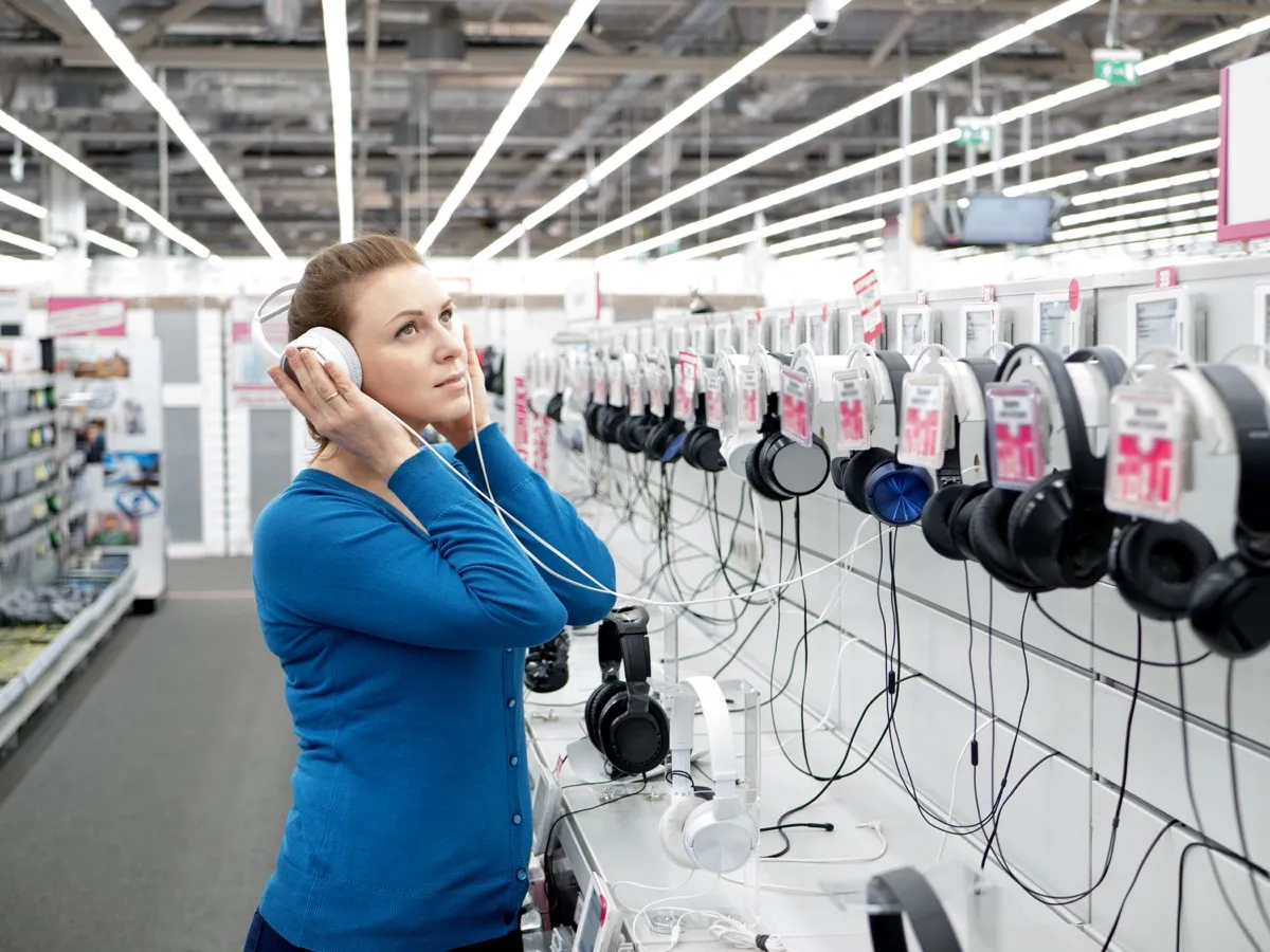 Woman Shopping at a Headphone Display {Shopping Tips}