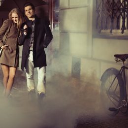 man and woman wearing long coats waking outside after a date