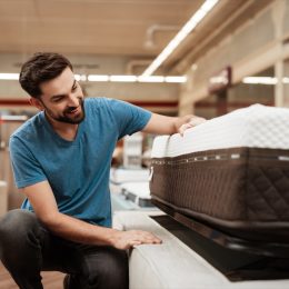 Man Inspecting a Mattress While Shopping, https://bestlifeonline.com/body-sleep/