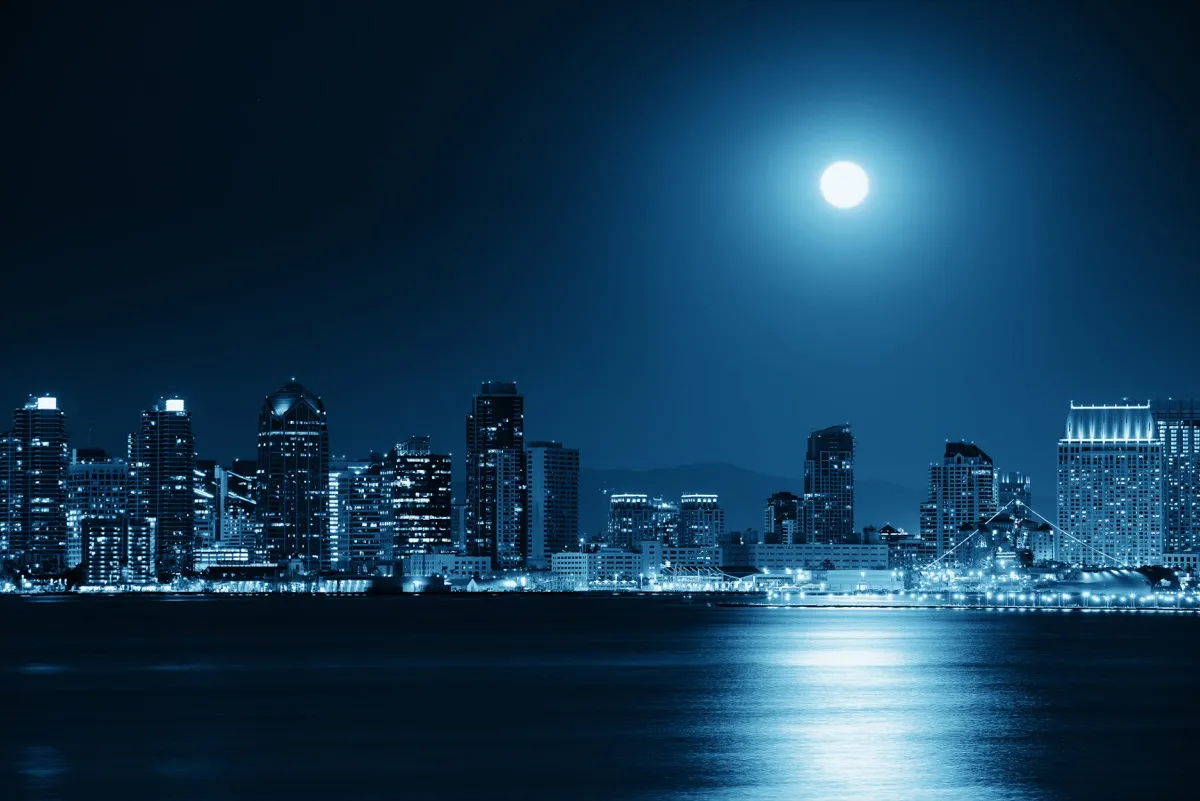 moon over the san diego skyline at night