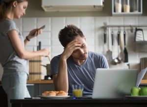 couple ignoring each other in the kitchen, things you should never say to your spouse