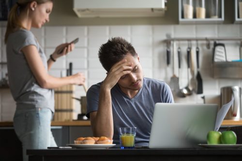 couple ignoring each other in the kitchen, things you should never say to your spouse