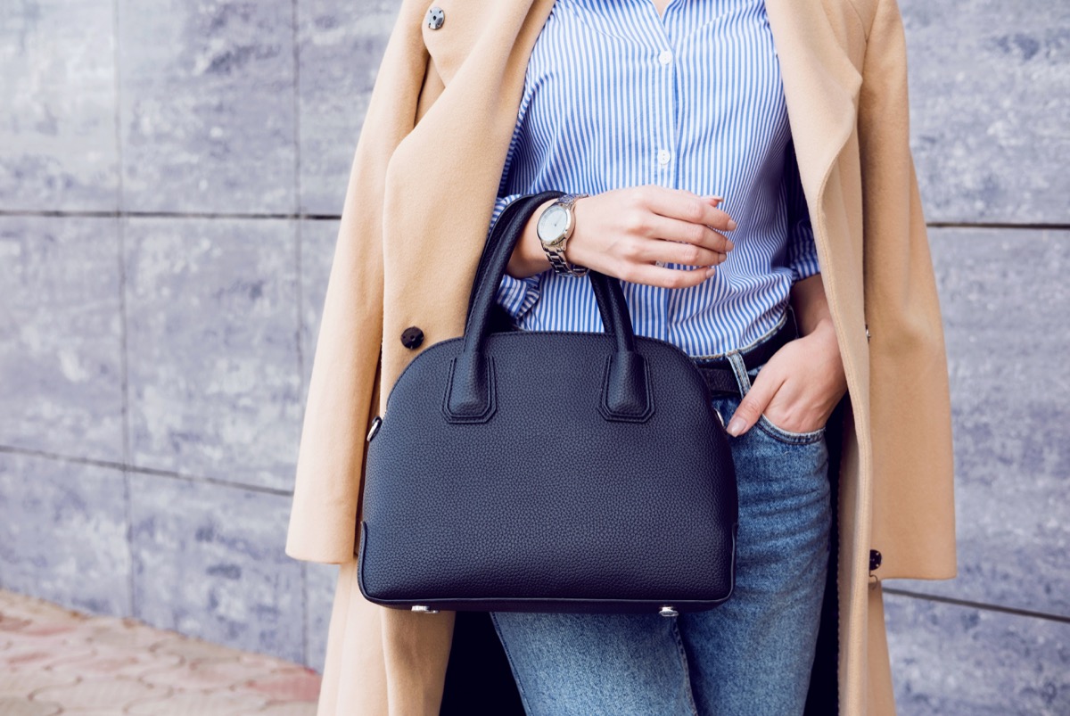 Stylish woman holding purse