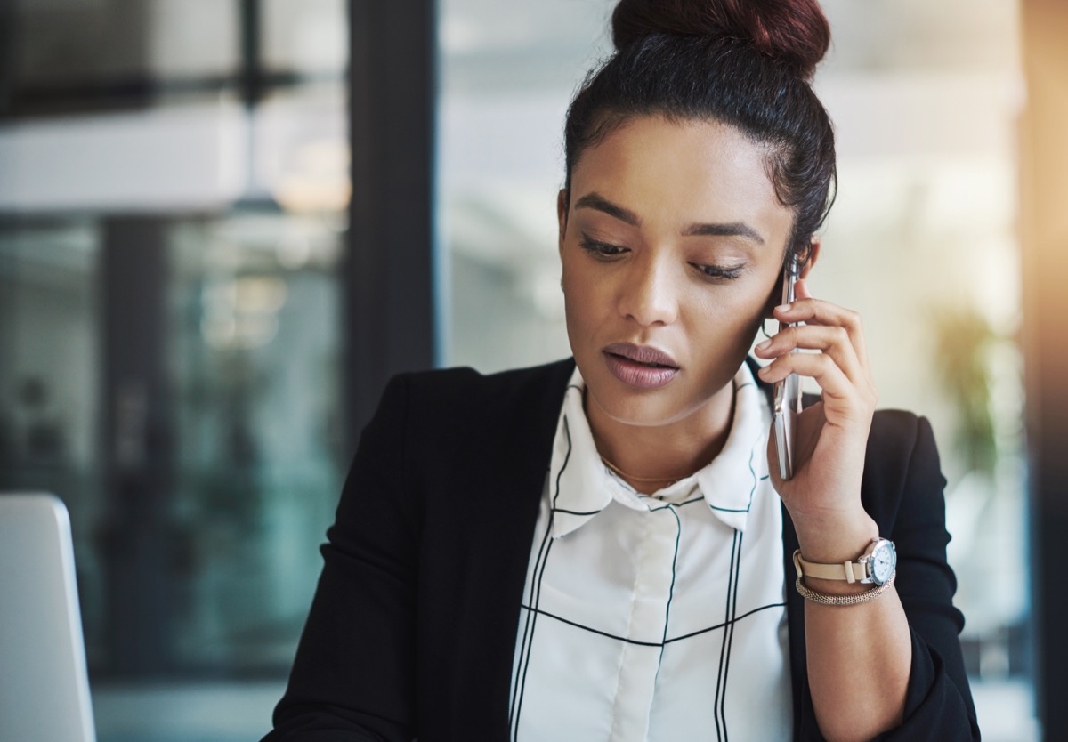 Shot of a young businesswoman using a mobile phone in a modern office