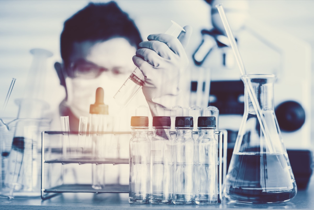 scientist with test tubes in a lab about to make a major breakthrough