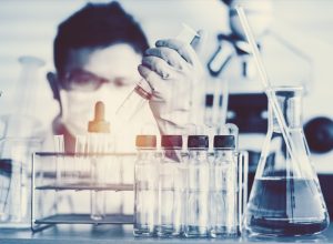 scientist with test tubes in a lab about to make a major breakthrough