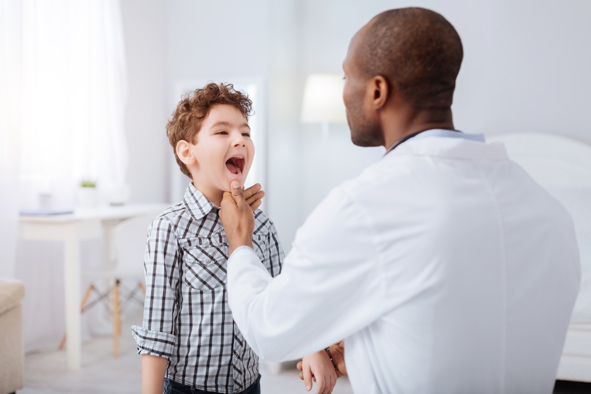 doctor looking in child's throat