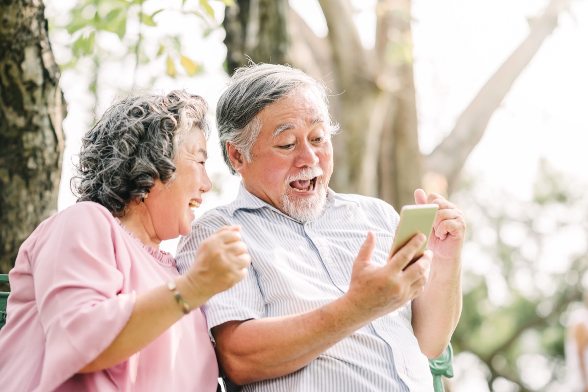 Older couple looking at a phone surprised