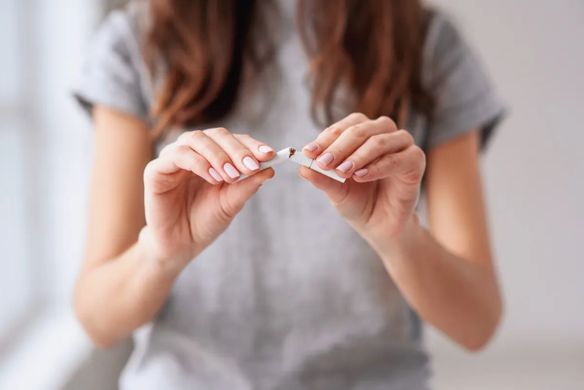 woman snapping a cigarette in half and quitting smoking, how parenting has changed