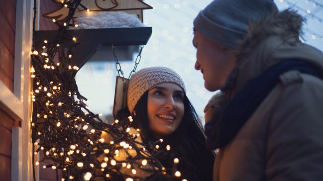 Young couple at a Christmas market, a tradition