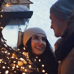 Young couple at a Christmas market, a tradition