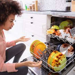 African American woman with a broken dishwasher