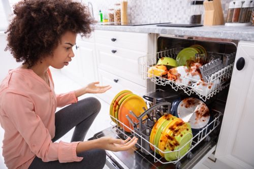 African American woman with a broken dishwasher