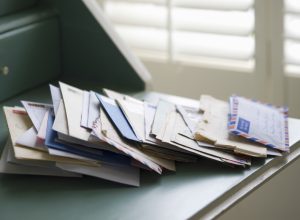 Pile of Mail on a Desk {Secrets Your Mailman Knows}