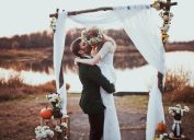 bride and groom kissing at a rustic wedding