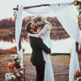 bride and groom kissing at a rustic wedding