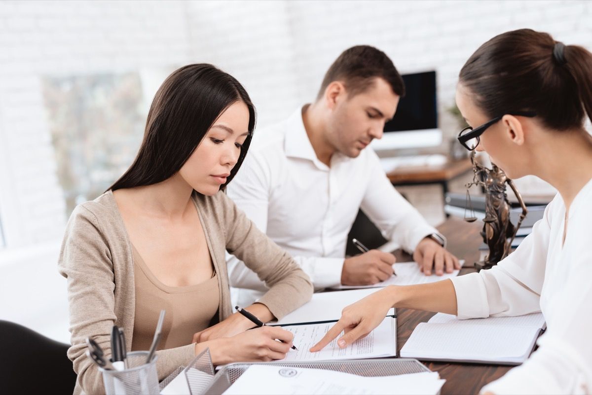 Couple signing divorce papers