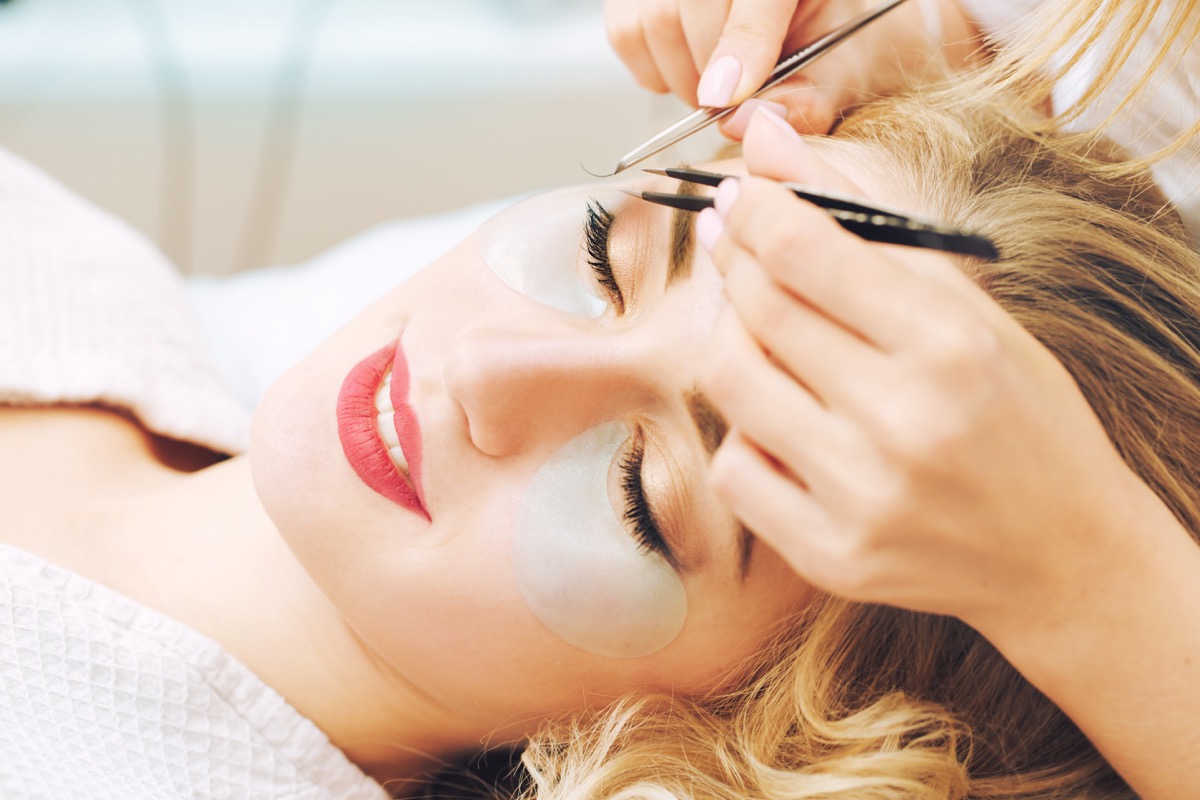 Eyelash extension procedure in beauty salon