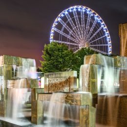 Vibrant Lights Illuminate Modern Fountain Sculpture in Night Scene with Seattle Great Wheel in Seattle, Washington