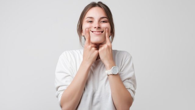 woman smiling on white background, what do you call jokes