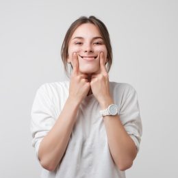 woman smiling on white background, what do you call jokes