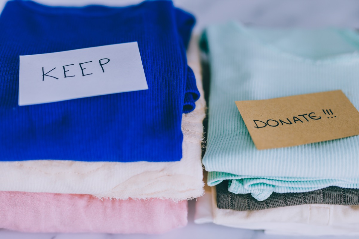 Keep and donate piles of clothes decluttering closet