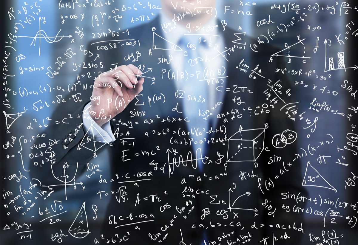 Man doing math equations on a board