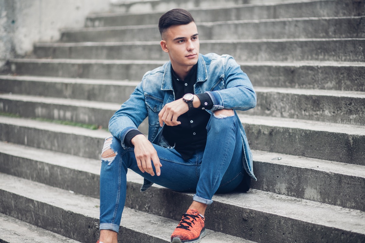 man wearing a denim jacket and jeans